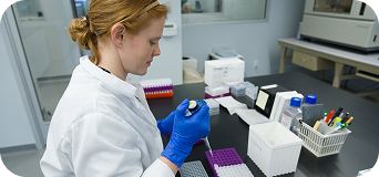 Woman piping a tube of DNA in a lab