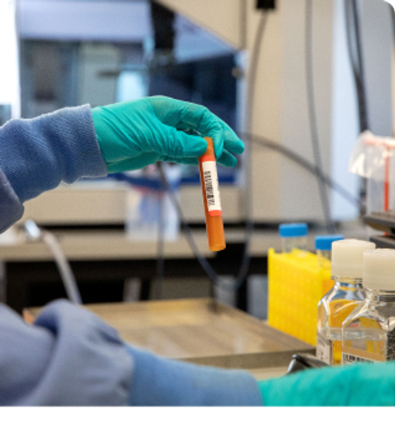 Scientist with container for DNA sample