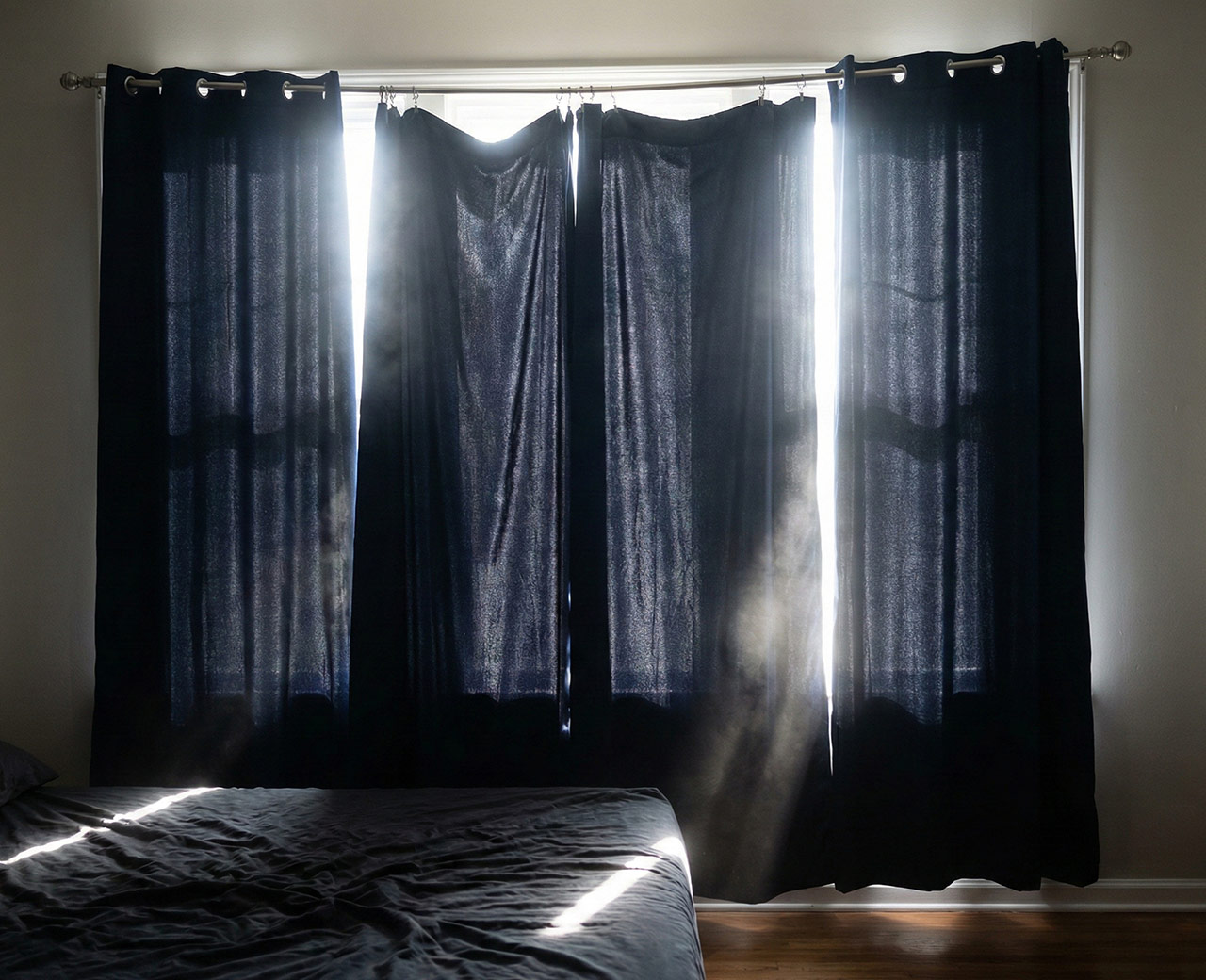 Blackout-curtains-with-light-leaking-around-edges-showing-installation-gaps.jpg