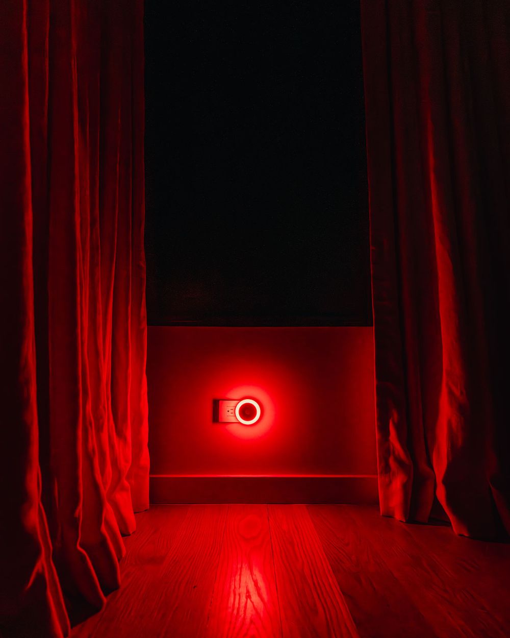 UBlockout motion sensor night light emitting circadian-safe red light in bedroom with blackout shades