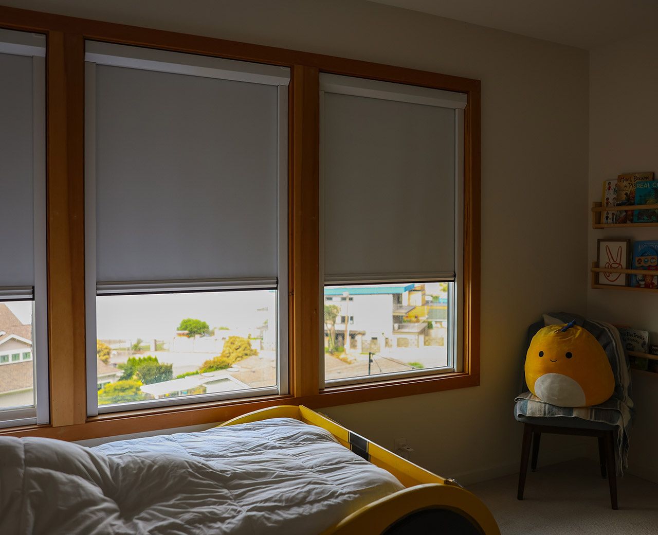UBlockout roller shades installed in child's bedroom blocking all light through sealed tracks
