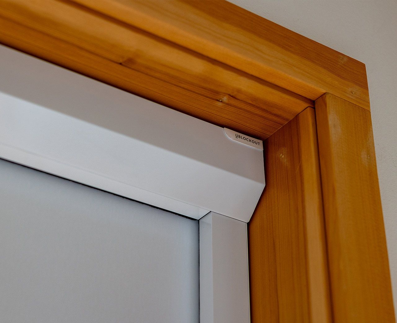 Close-up of uBlockout blackout shade headbox and sealed side track installed in window frame
