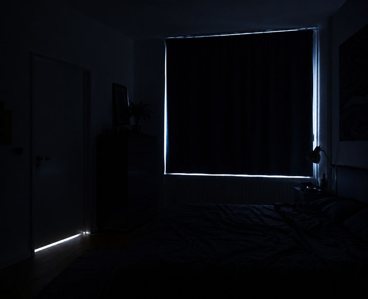 Dark bedroom with multiple unwanted light sources including streetlight around curtain edges, a glowing LED and light under the door
