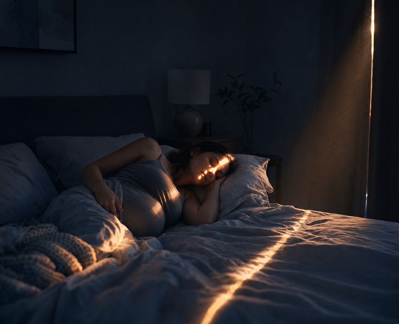 Early morning sunlight leaking through a gap at the edge of a window covering onto a bed