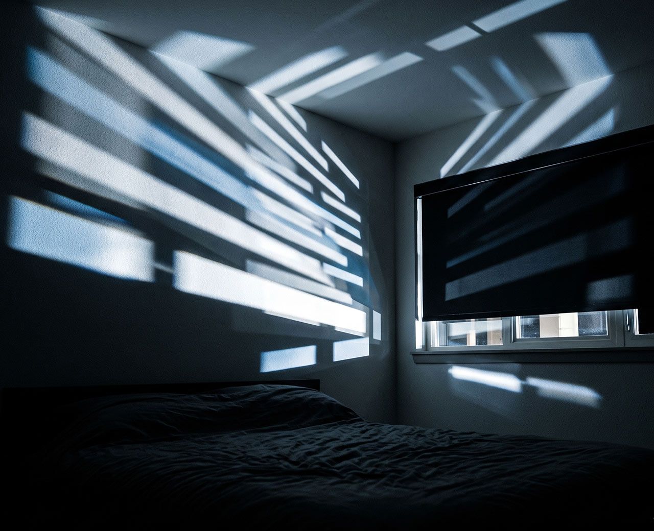 Shifting headlight shadows moving across a dark bedroom wall through a gap at the window
