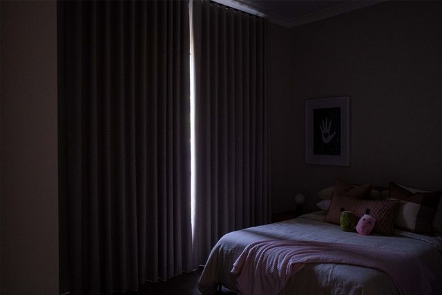 Traditional blackout curtains in child's bedroom with light leaking through center gap where curtains meet, demonstrating incomplete light blocking..jpg