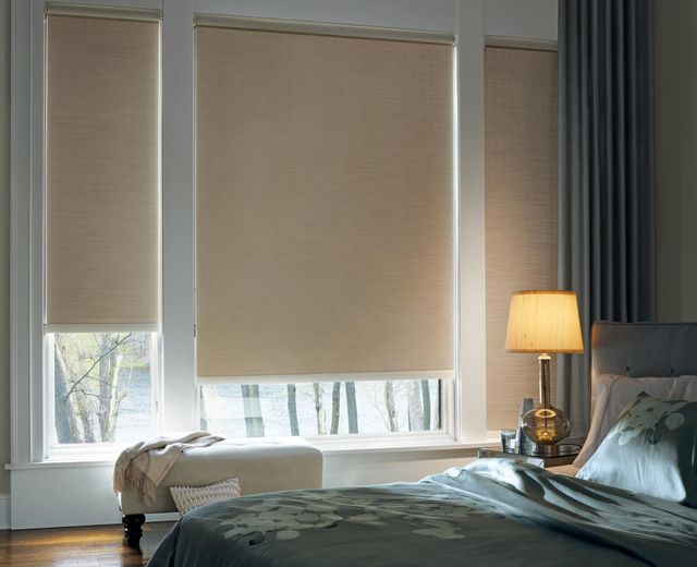 Room-darkening-roller-shades-with-light-leaking-through-fabric-and-edge-gaps-in-bedroom..jpg