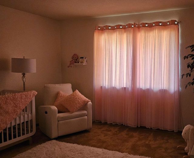 Nursery-with-inadequate-light-blocking-curtains,-sunset-light-glowing-through-sheer-fabric-near-baby-crib..jpg