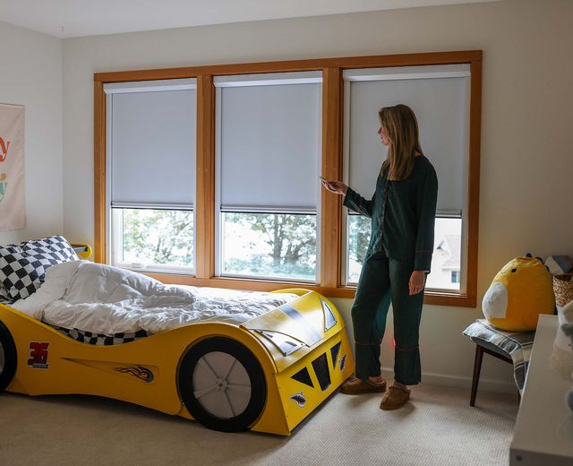 Mother-adjusting-UBlockout-blackout-shades-in-child's-bedroom,-light-gaps-visible-before-shades-reach-full-100%-light-blocking-position..jpg