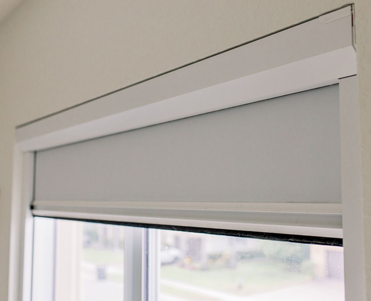  UBlockout sealed-track roller shade installed flush against window frame with no light leakage
