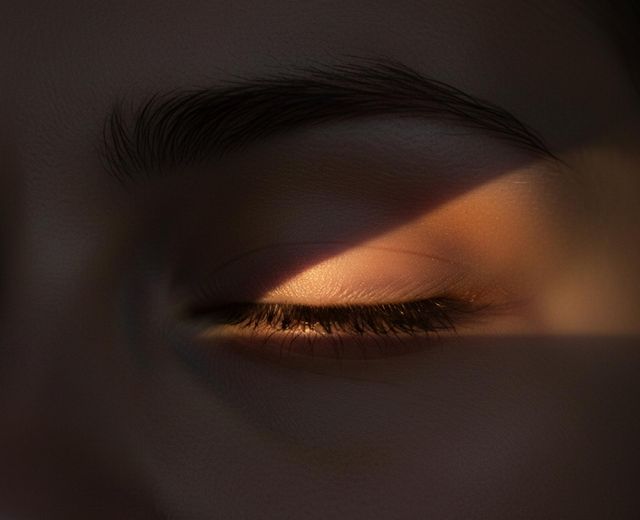 Close-up of closed eye with light penetrating eyelid during sleep