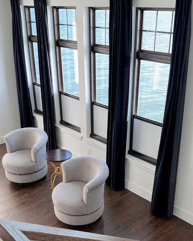 Waterfront living room with floor-to-ceiling windows featuring UBlockout top down bottom up shades in bottom-up position preserving ocean views