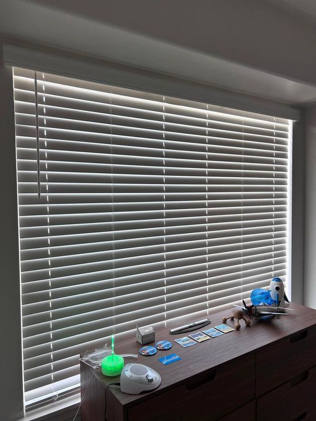 Standard blinds with light filtering through slats showing incomplete blackout