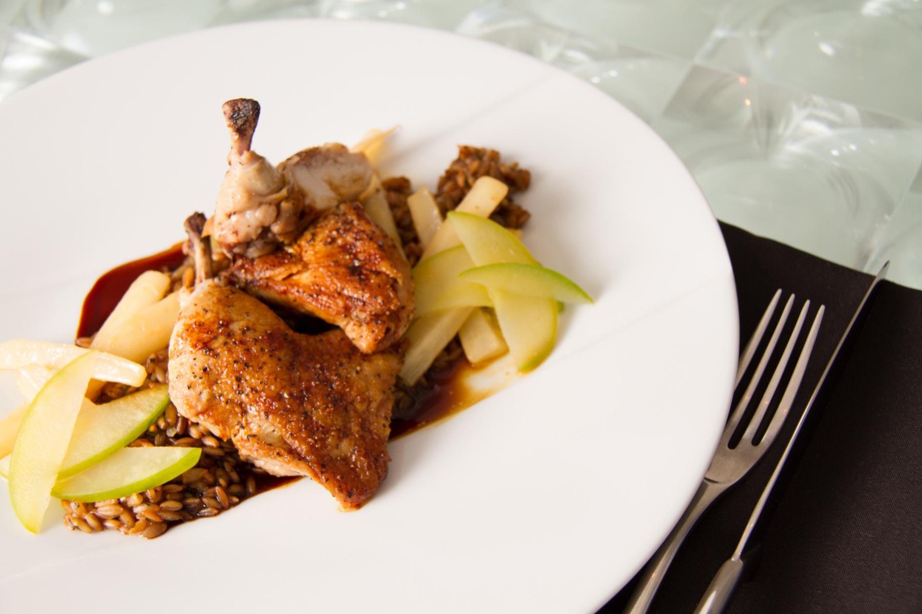 Raspberry Cornish hen on white plate.