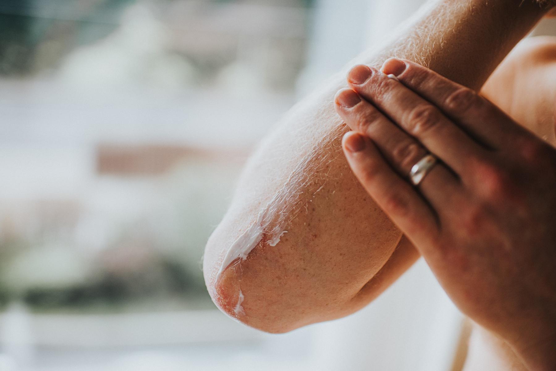 Woman moisturizing her elbow.