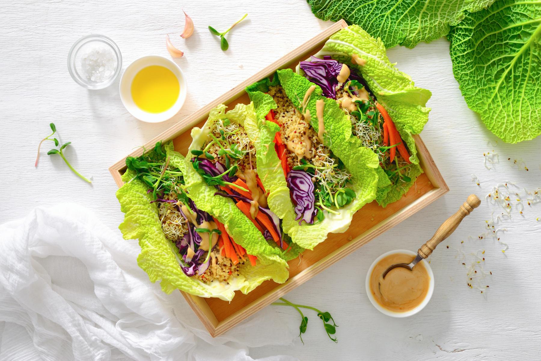 3 tofu lettuce wraps on wooden tray.