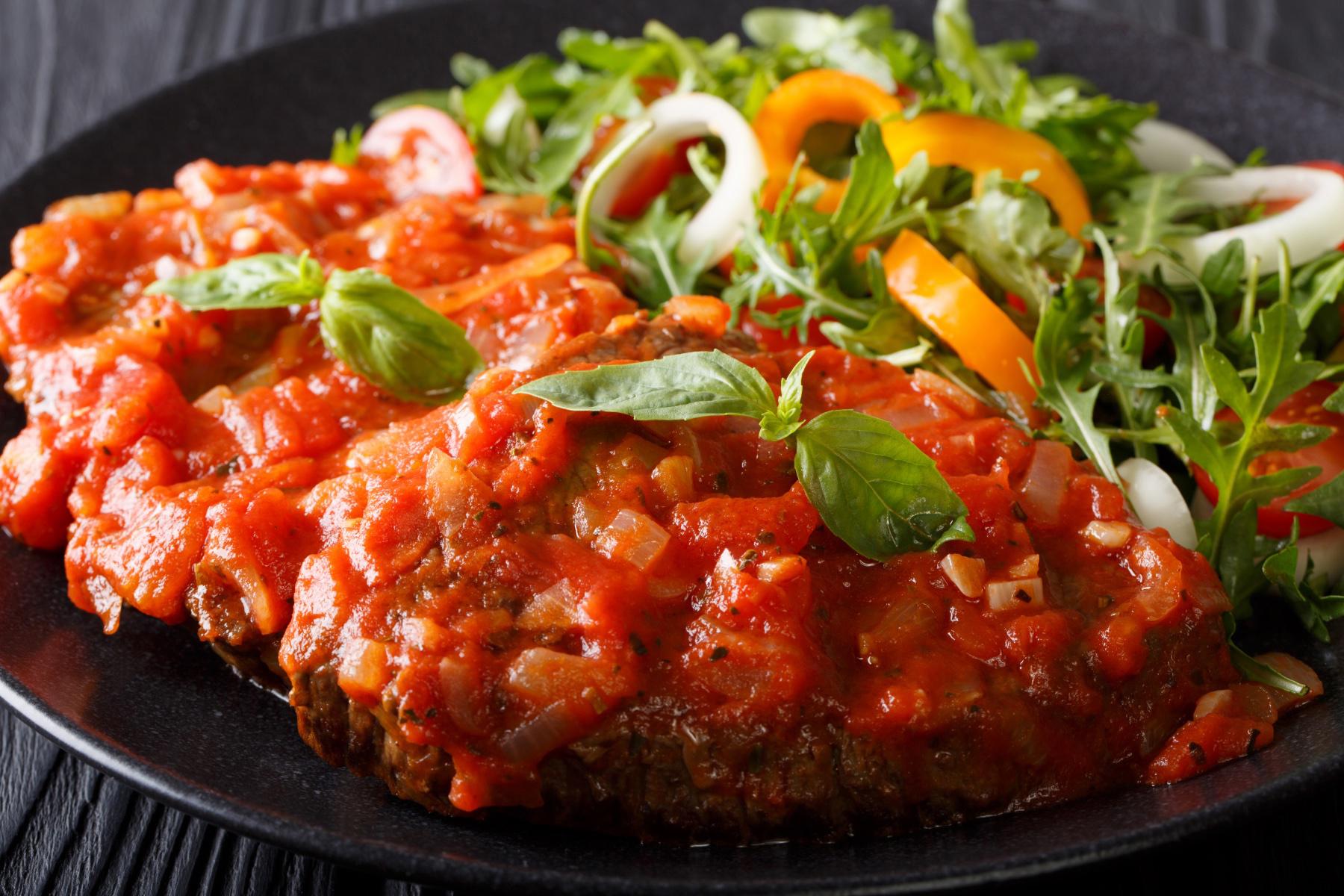 A plate of steak pizzaiola.