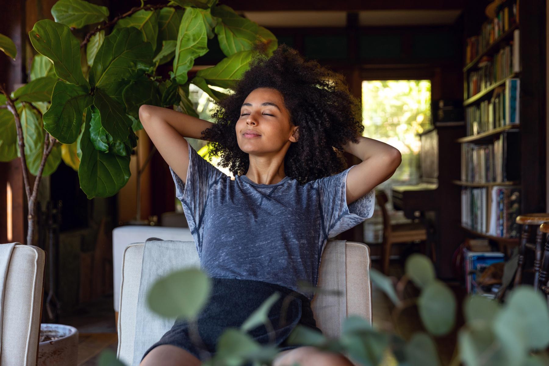 Woman relaxing with her hands behind her head.