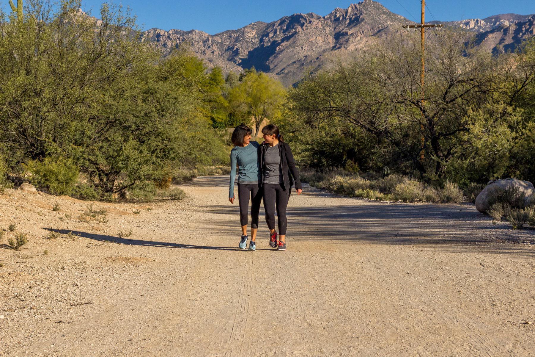 Two women walking a hiking trail at Canyon Ranch Tucson.
