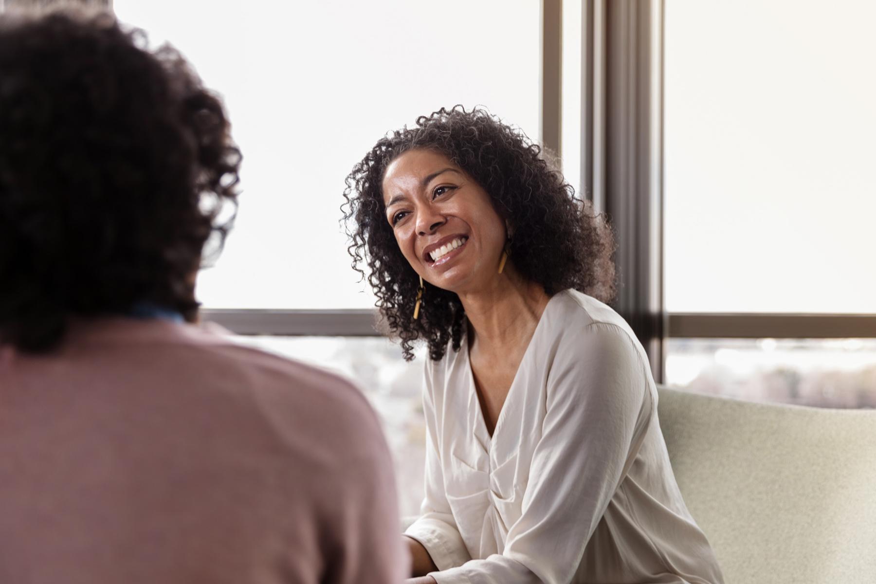 A spiritual counselor smiling at her client.