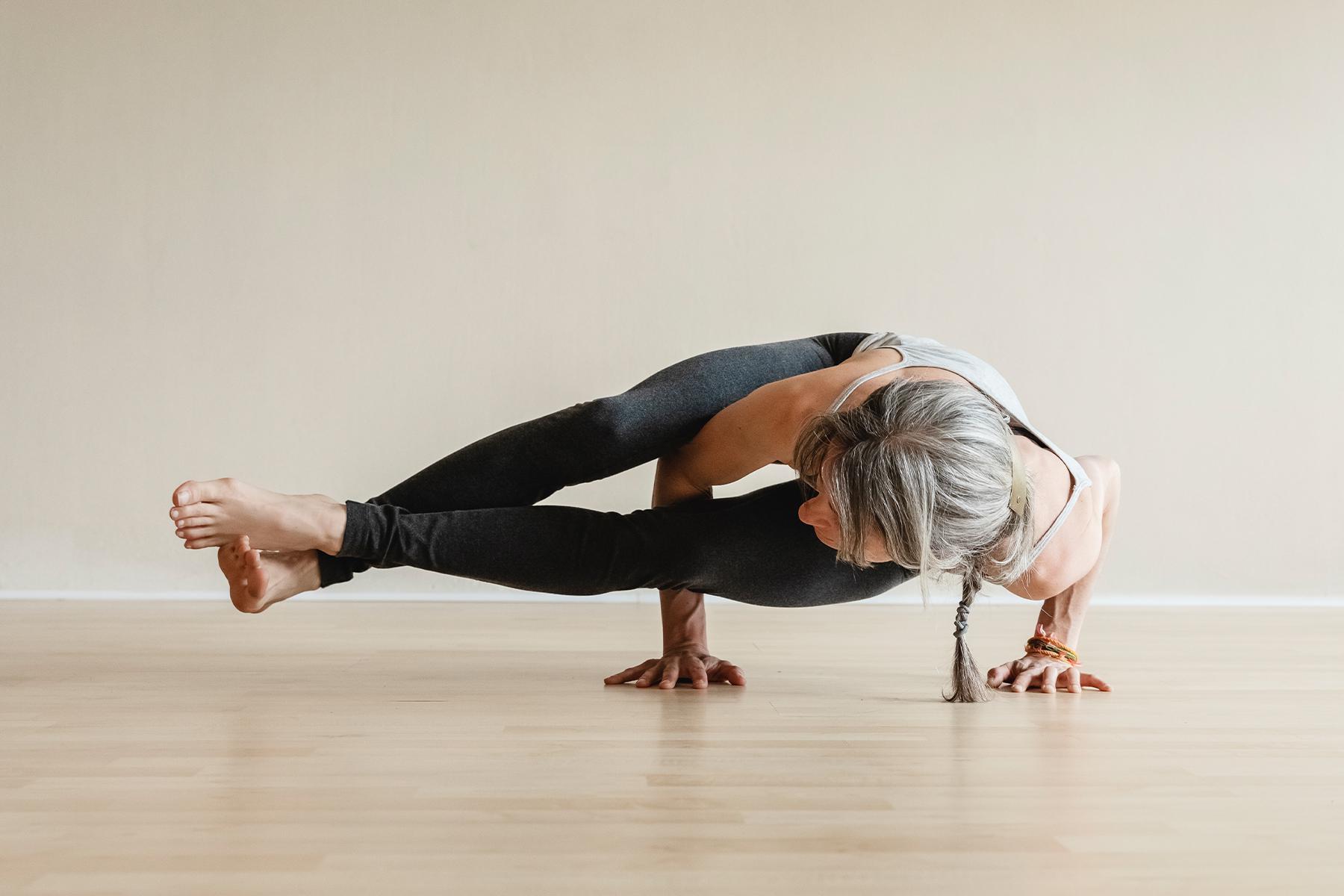 close-up of woman doing side plank in yoga studio