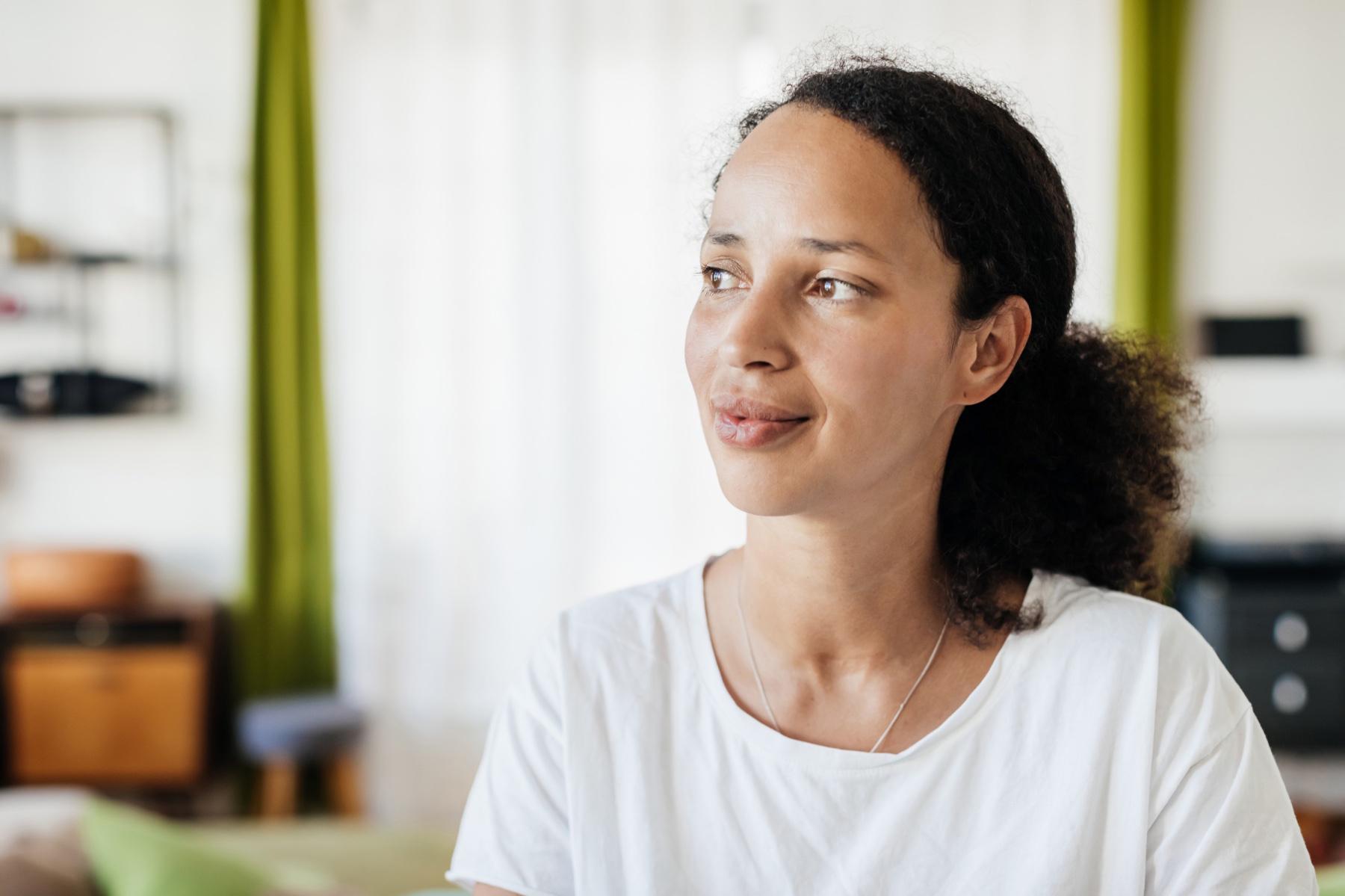 Woman looking off to the side with a slight smile.