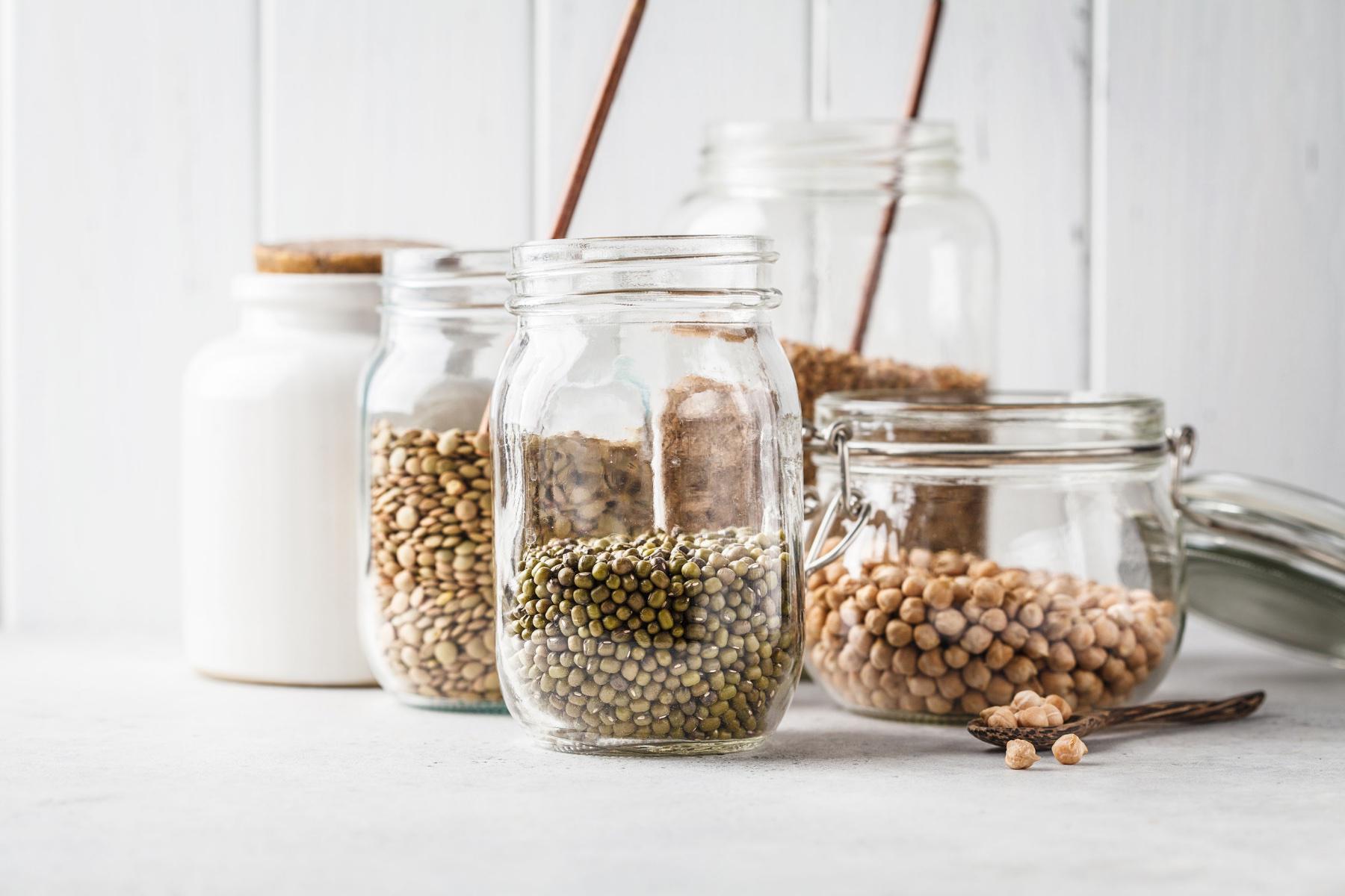 close-up of dry pantry goods including beans in mason jars
