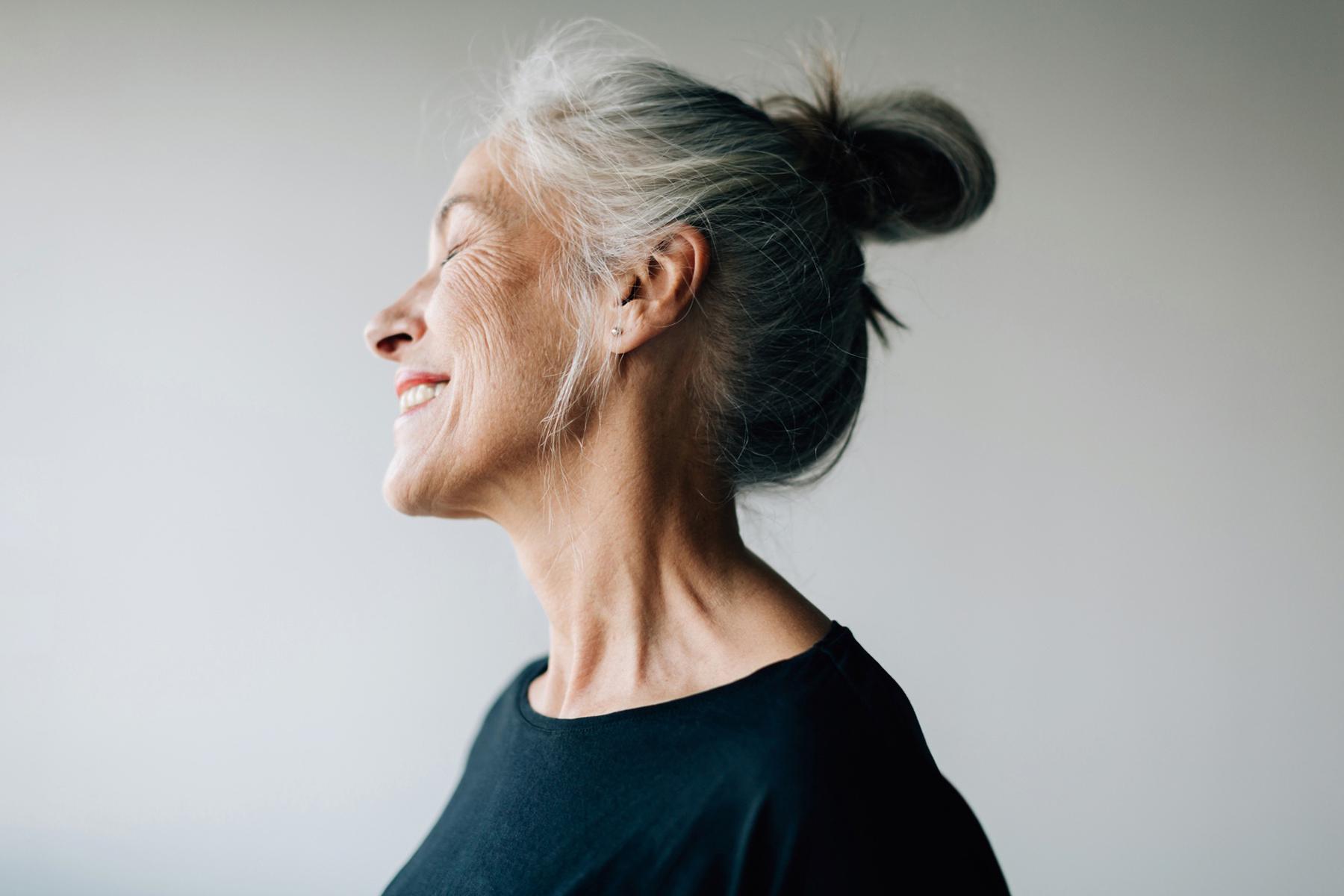 A mature woman smiling.