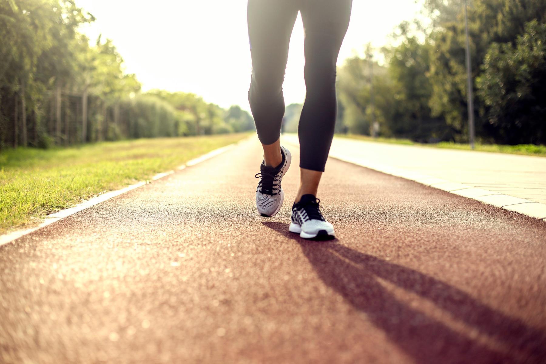 close-up of woman's legs as she walks down sidewalk