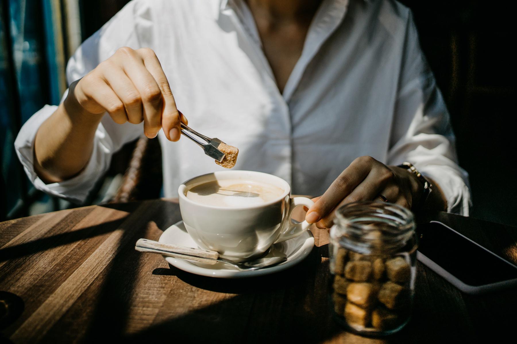 woman dropping star cube into coffee