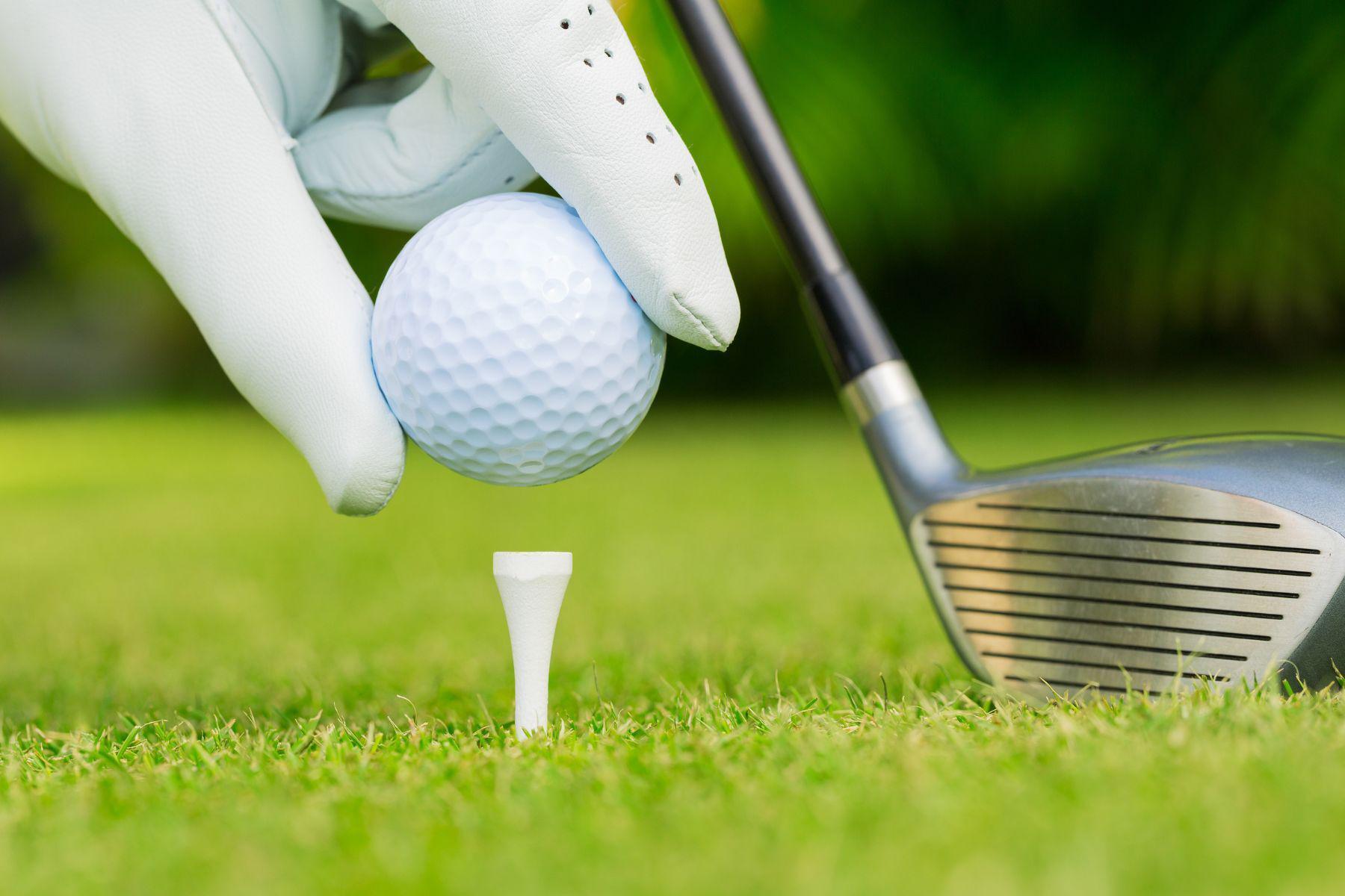 Placing a golf ball on tee.