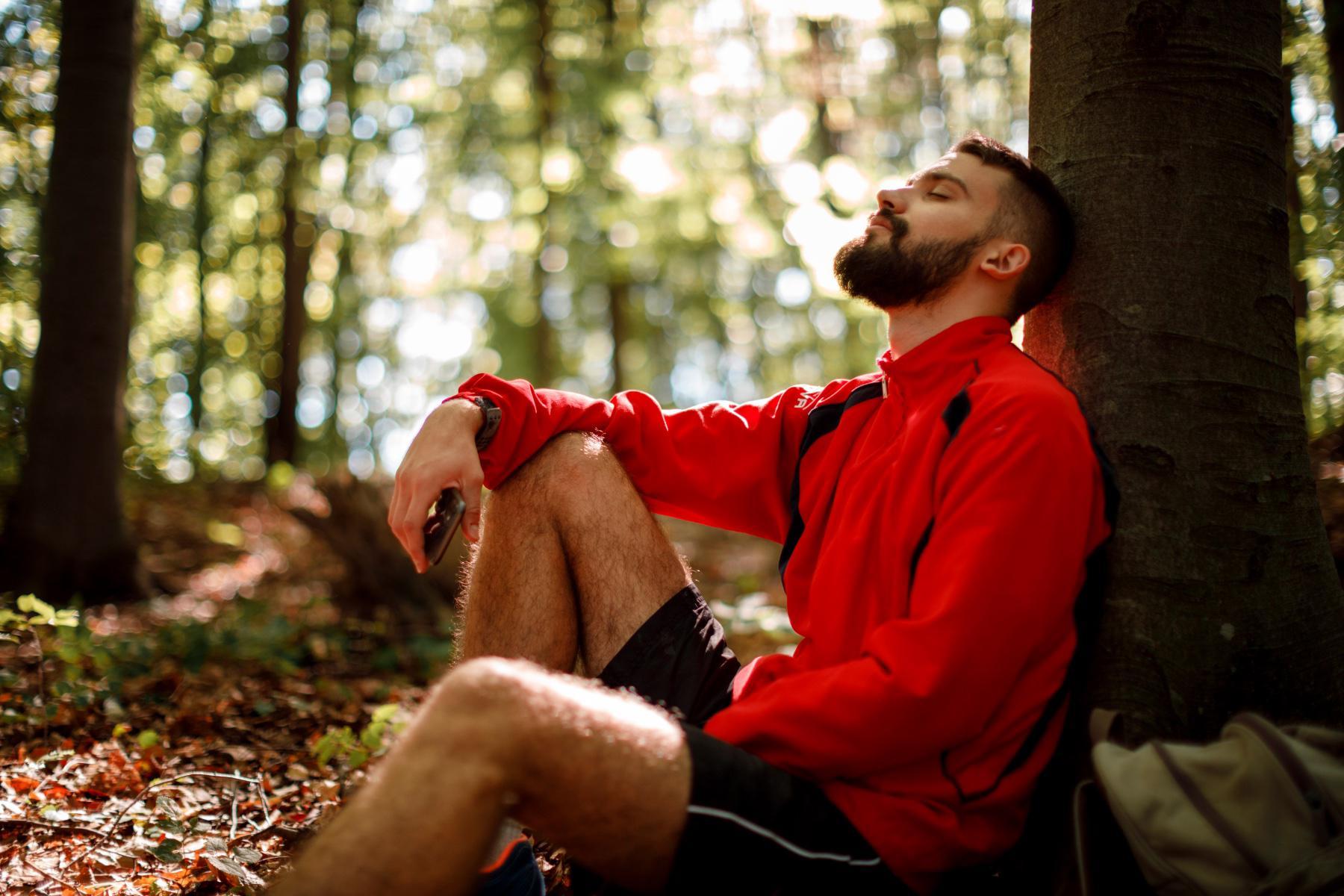 A man relaxing in a forest.