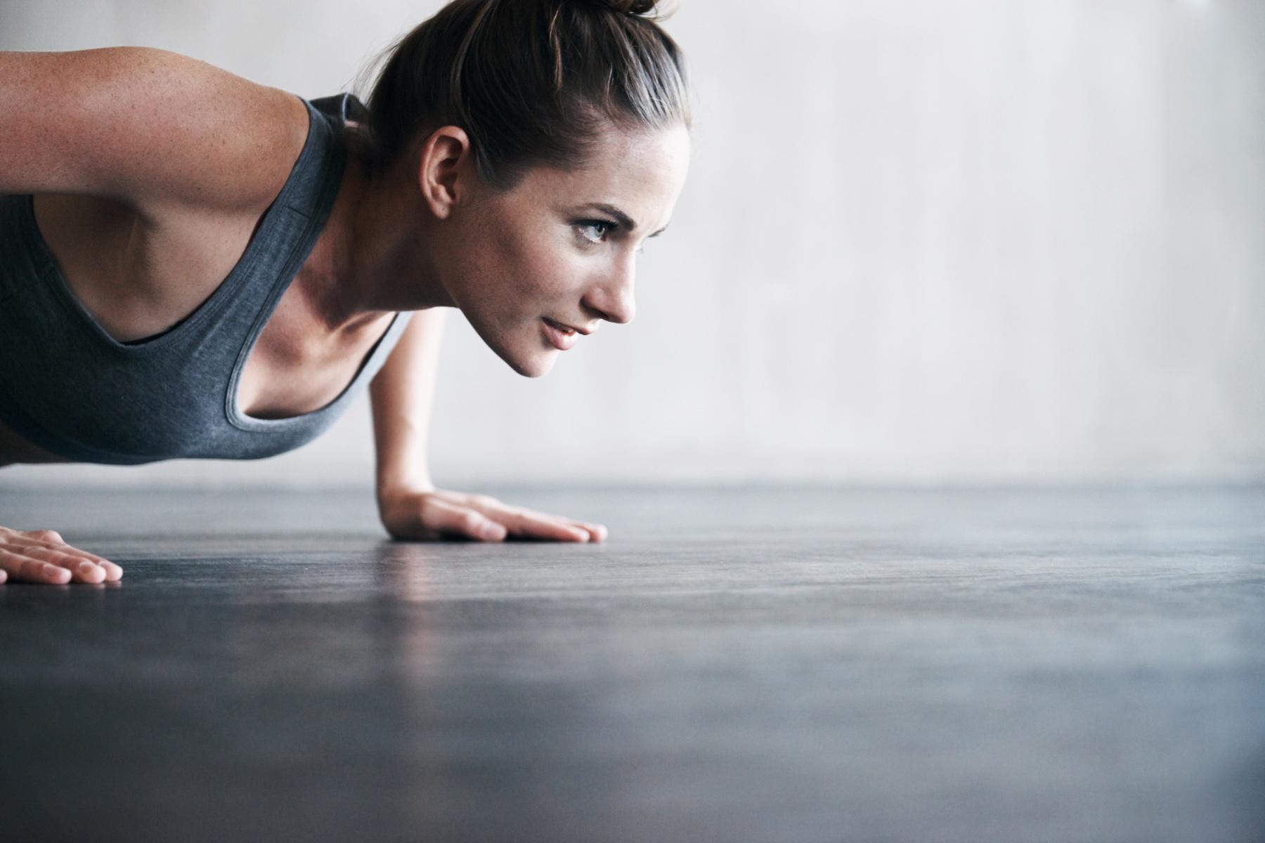 close-up of woman's face from side as she does a push-up