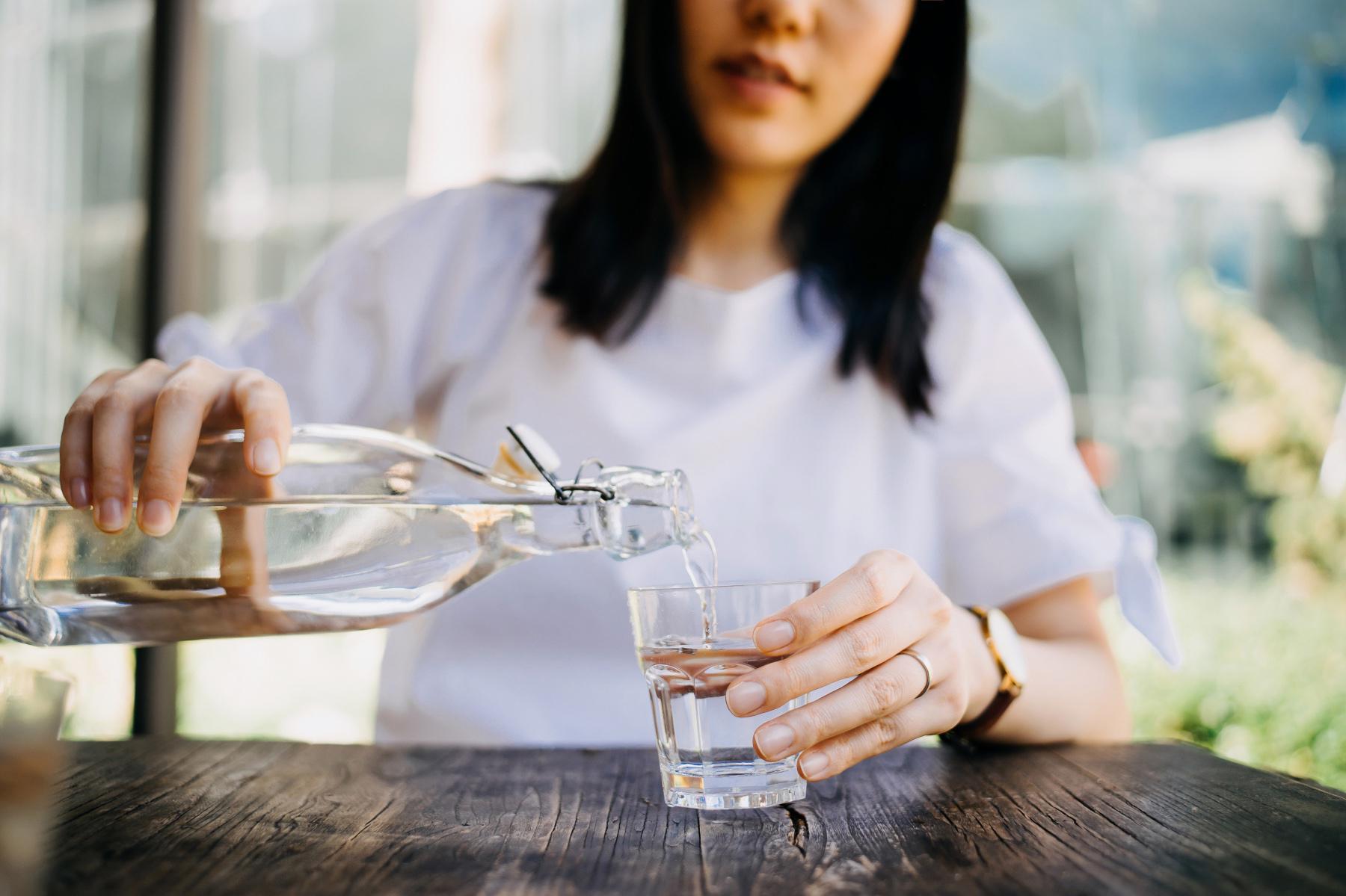 woman pouring glass of water