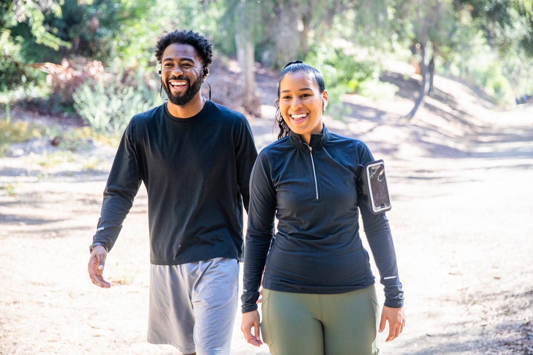 young, smiling, couple in workout clothes walking together on a path in Tucson, Arizona