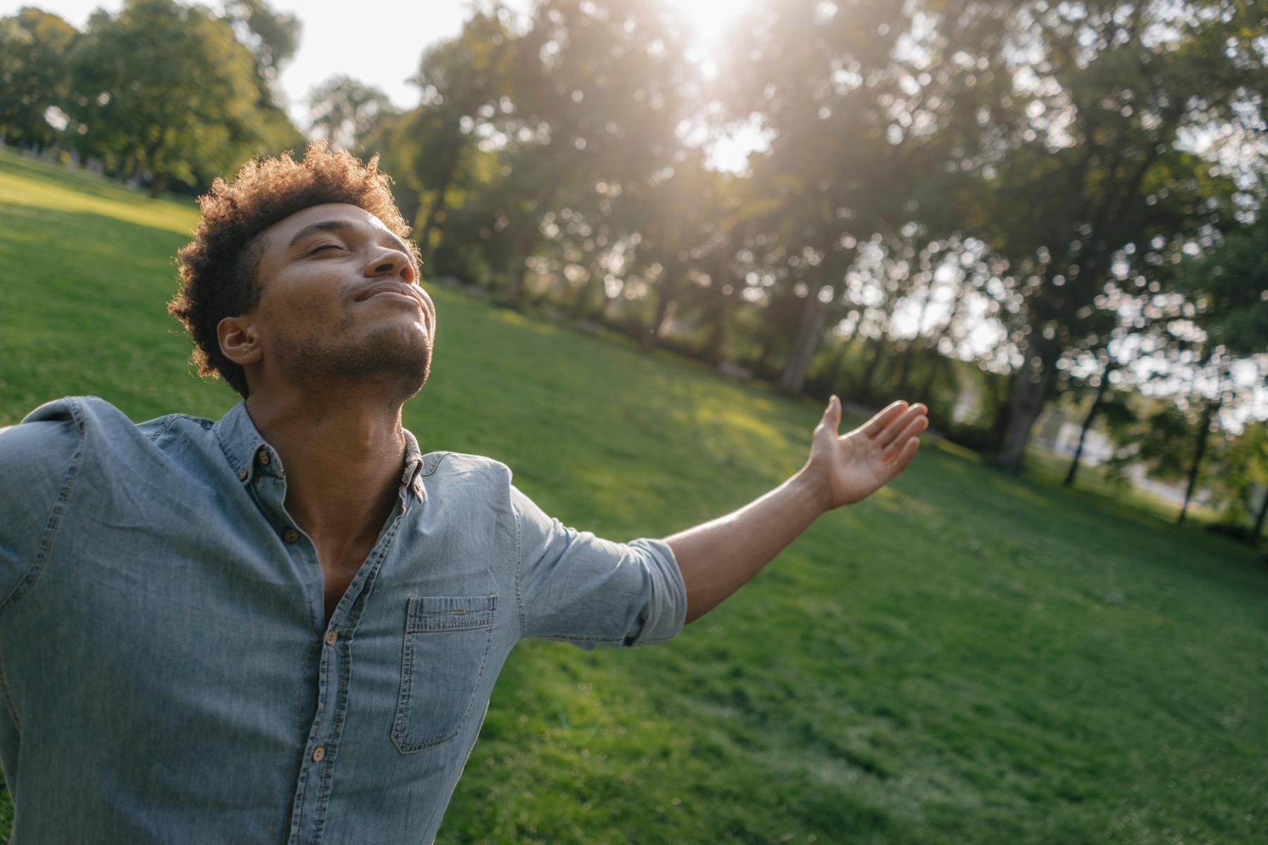 Man with his arms outstretched towards the sky.