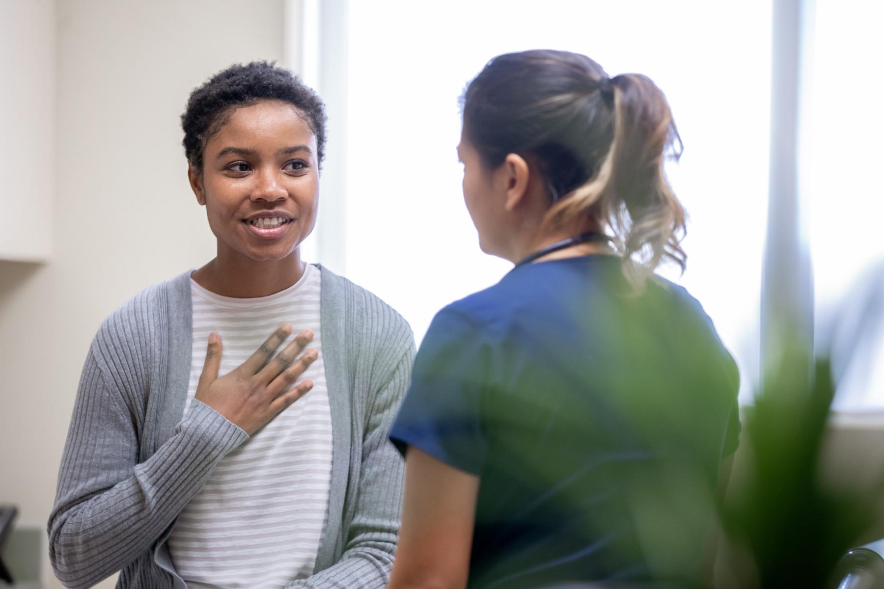 Woman talking to doctor.