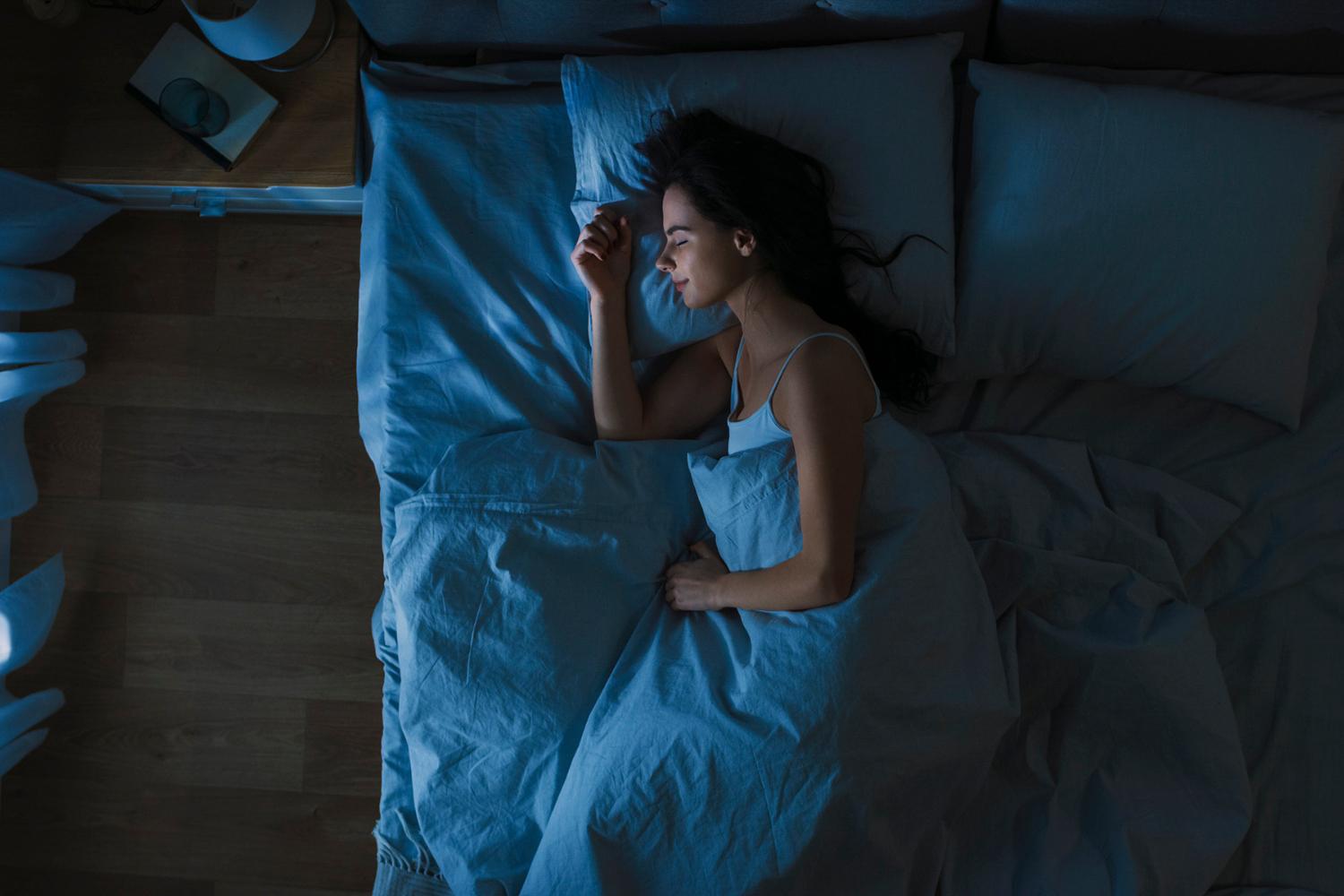 a woman sleeping soundly in bed
