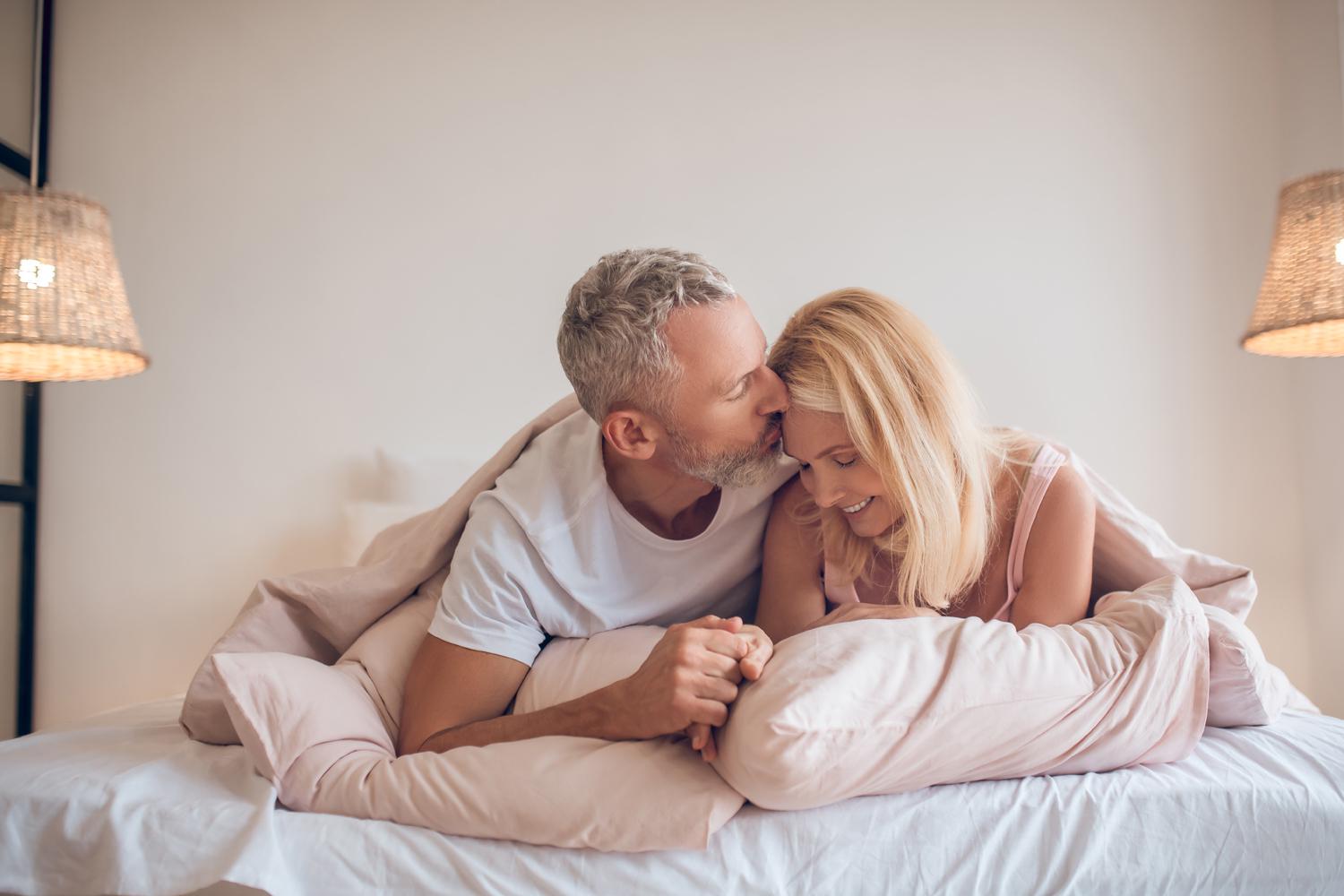 A couple hugging in a bed