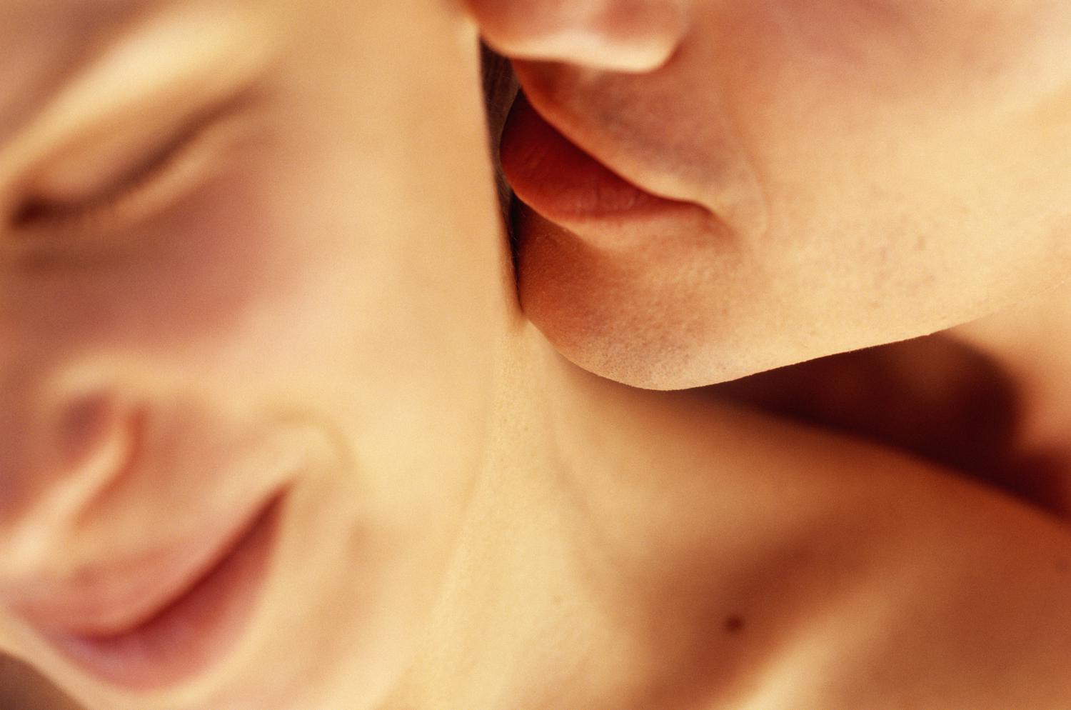 a man kissing a womans neck