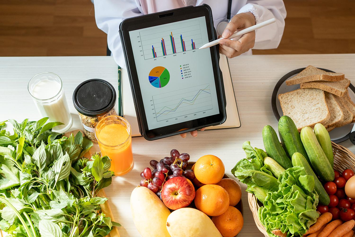 a display of food and a pie chart on a tablet