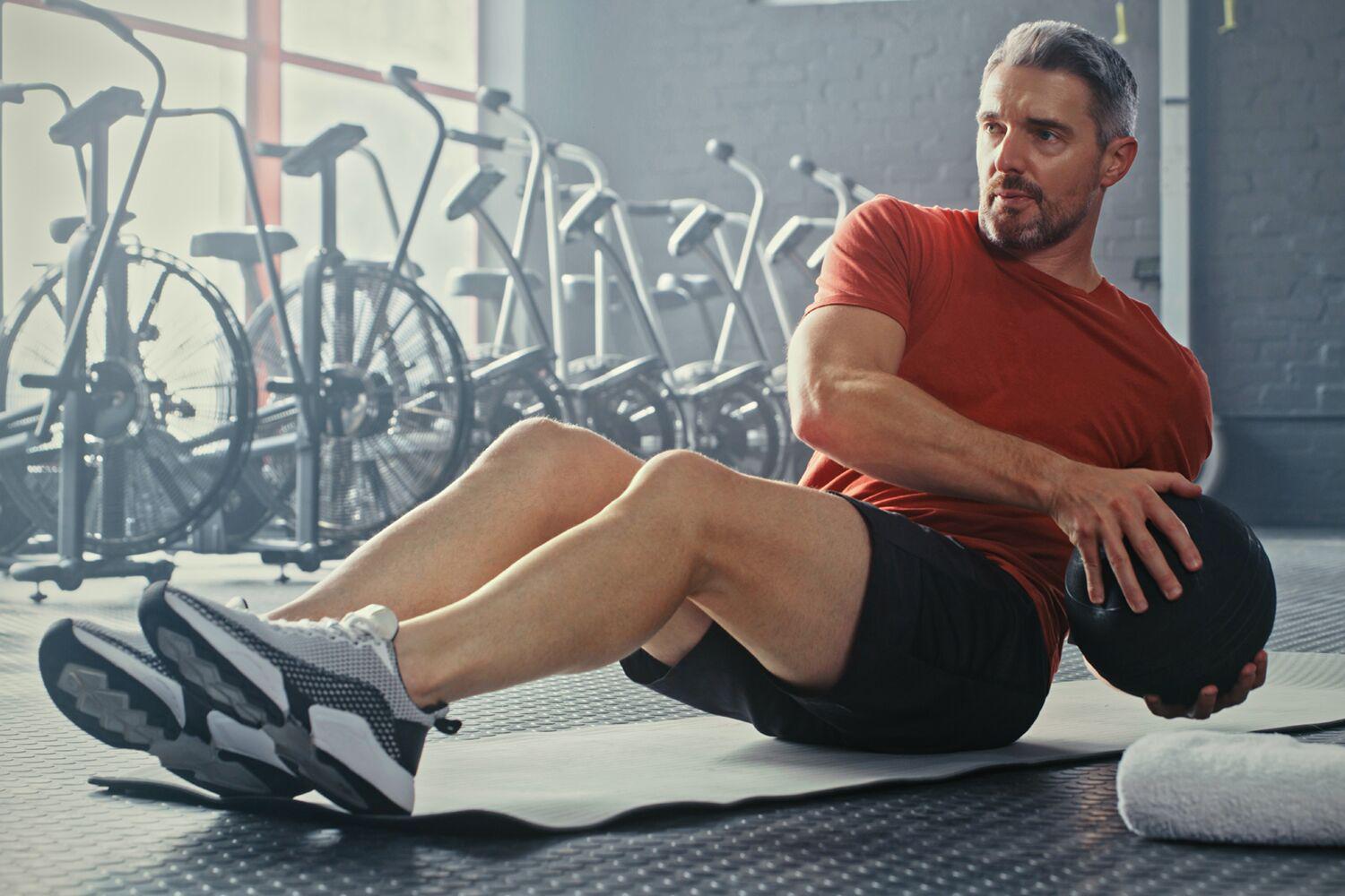 Man working in the gym with a medicine ball
