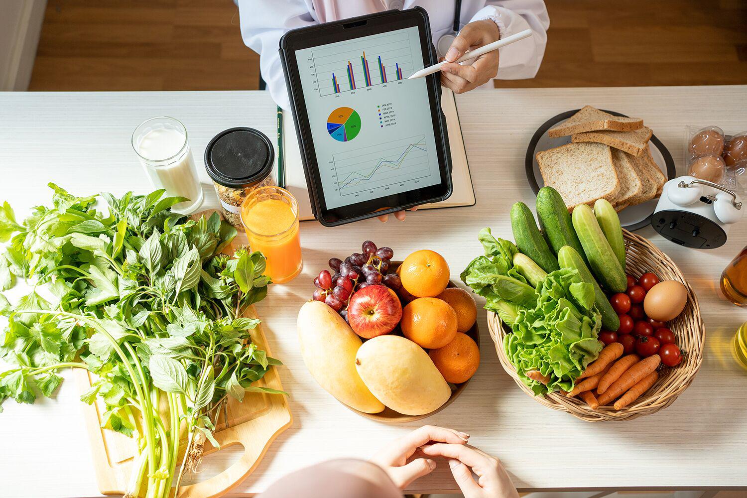 a spread of healthy ingredients and a pie chart with a diet score test from Canyon Ranch Lenox Fitness + Spa Resort