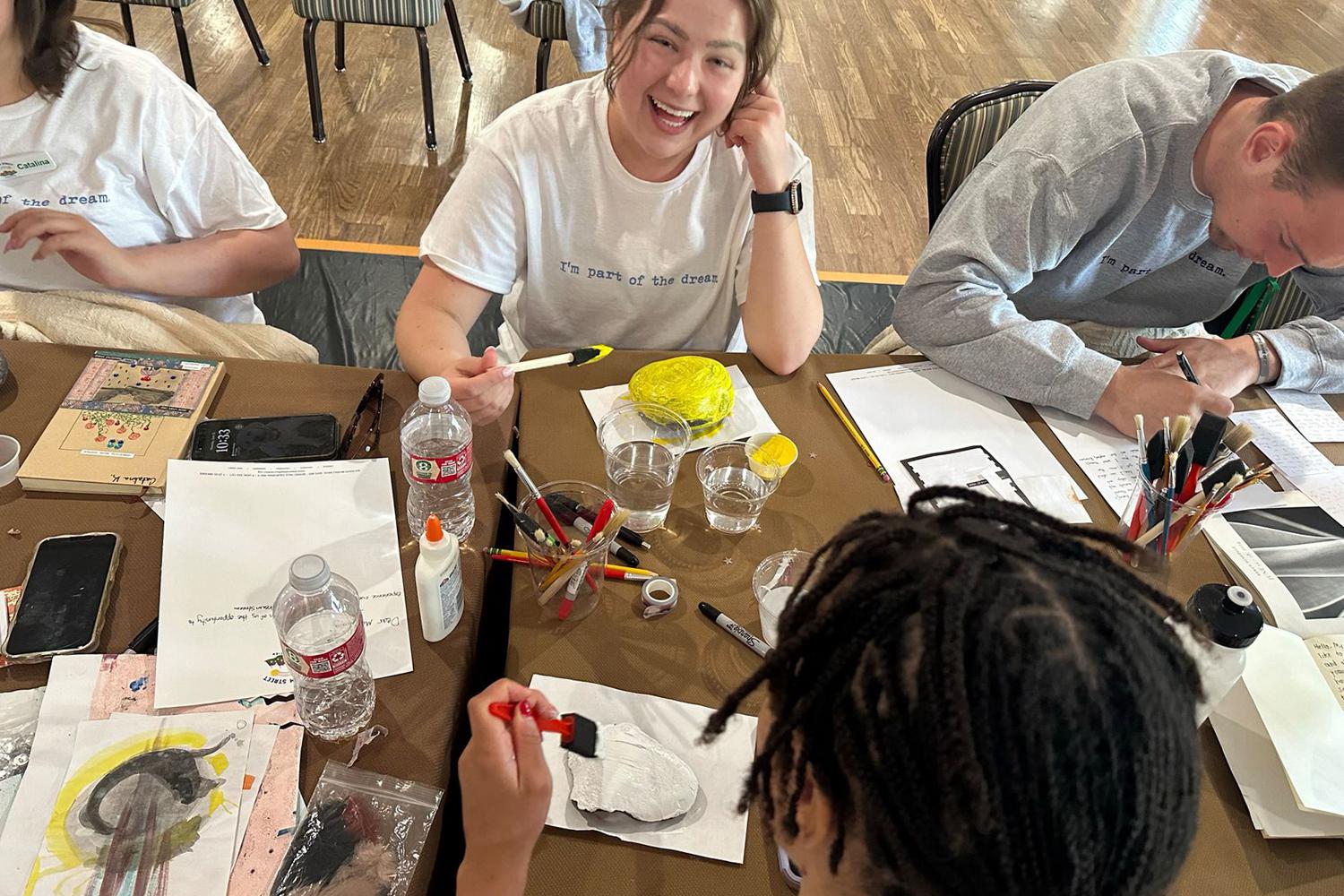 a group of participants laughing and doing art at the Dream Street Retreat program in Canyon Ranch Tucson Health + Wellness Resort