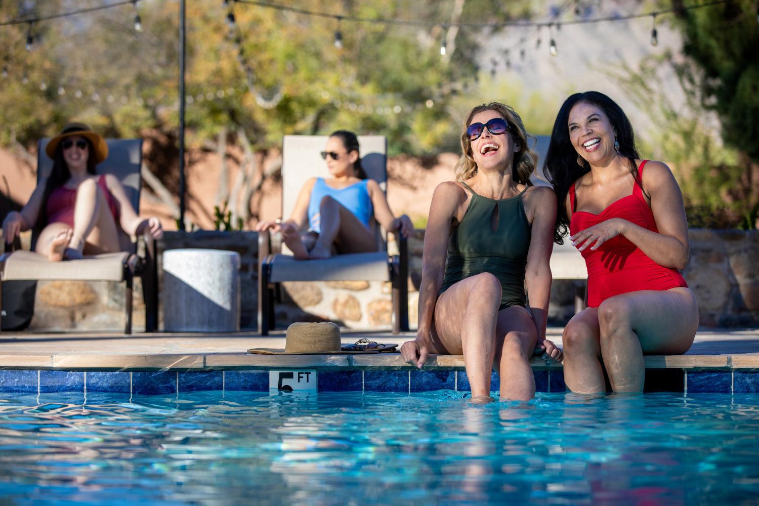 Women laughing at the flagstone pool at Canyon Ranch Tucson Health Spa Resort