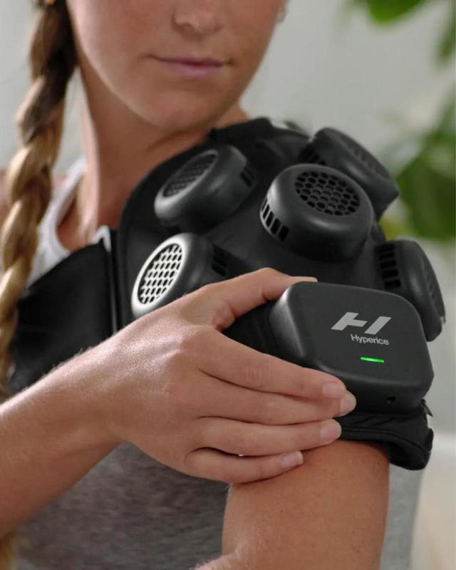 A woman using Hyperice cold therapy at Canyon Ranch Fort Worth Wellness Club