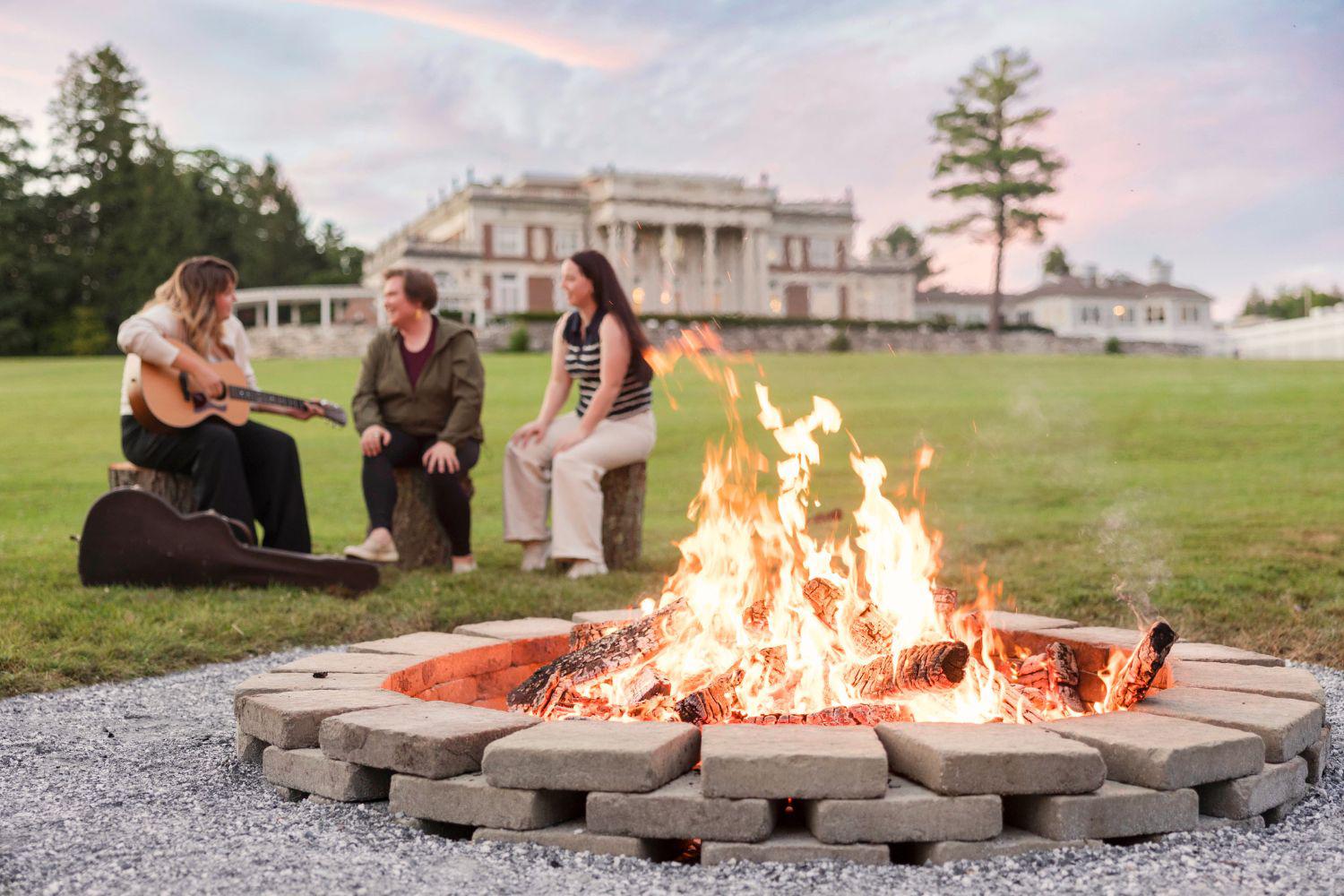 A group having a sing along by a campfire