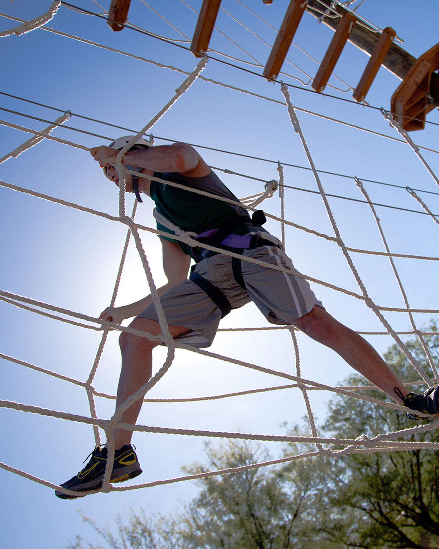 A man on a high-ropes course.