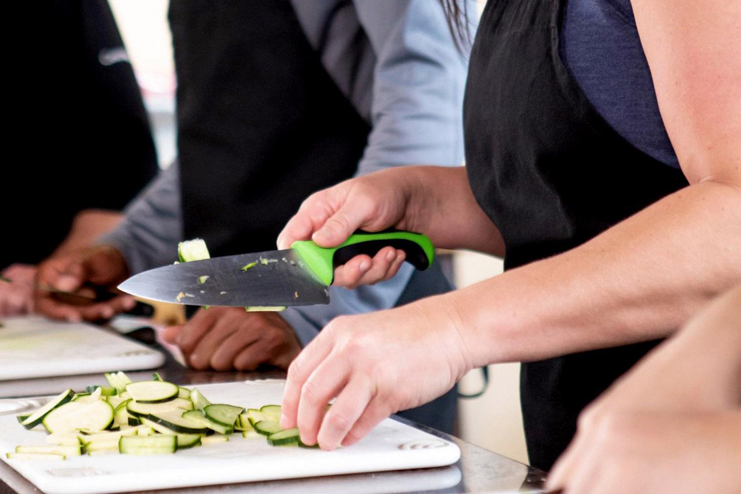 group of guests enjoying hands on cooking instruction in the demo kitchen.