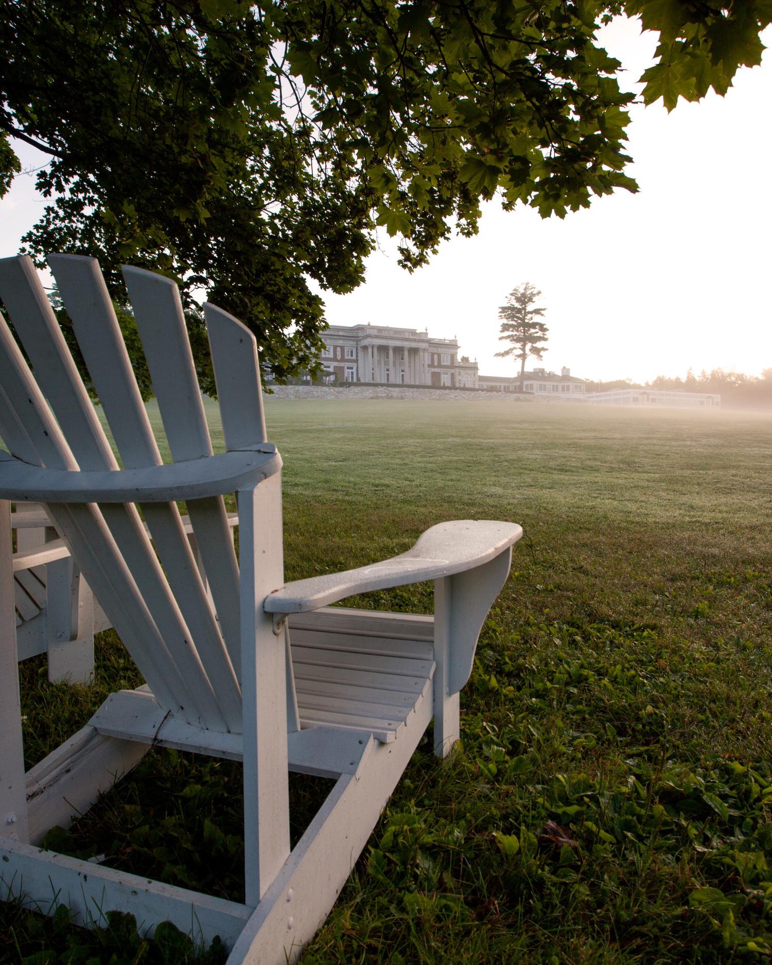 Close-up of Adirondack chairs on lawn.